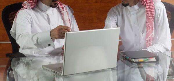Two,Saudi,Businessmen,Meeting,,Working,On,A,Laptop